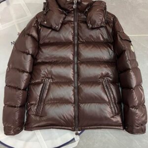 A glossy dark brown puffer jacket featuring horizontal quilting, a detachable hood, and a signature snap-pocket on the left sleeve with a logo patch.