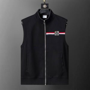sleeveless zip-up vest with a high collar, featuring a small rectangular patch on the chest with a white, red, and black tri-color stripe and a stylized logo.