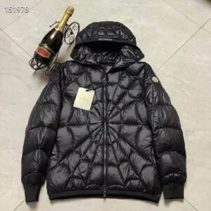 Glossy black puffer jacket with spiderweb quilting pattern, attached hood, and tags, lying on a tiled floor next to a bottle of champagne.