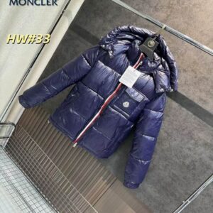 A shiny navy blue Moncler-inspired puffer jacket with a red, white, and blue striped zipper and a logo patch on the chest pocket.