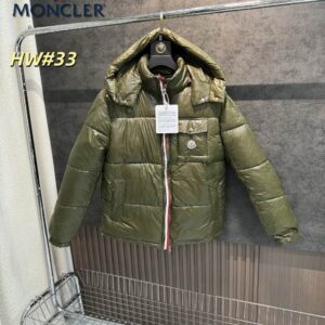 A shiny olive green Moncler-inspired puffer jacket with a red, white, and blue striped zipper and a logo patch on the front pocket.