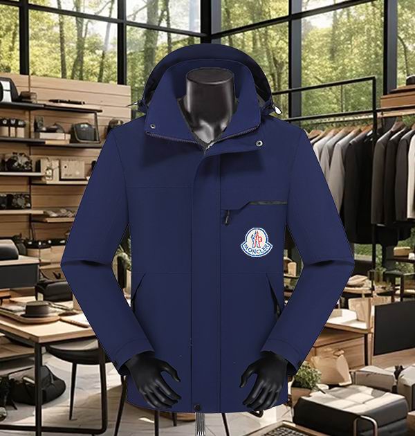 Brown men's Moncler-style waterproof jacket displayed on a mannequin, featuring a concealed hood, an angled chest pocket zipper, and a round, multicolored Moncler-style logo patch on the chest