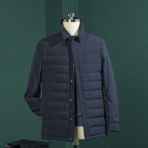 A deep navy blue horizontal quilted jacket featuring a structured turn-down collar, hidden front zipper, and adjustable button cuffs.