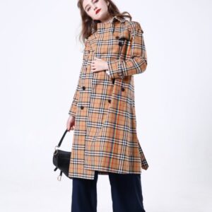 A long-length, double-breasted trench coat in a checkered cotton pattern with vibrant rainbow stripes, featuring a belted waist and traditional storm flaps.