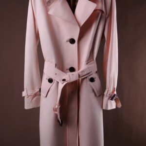 A midi-length, single-breasted women’s trench coat in honey beige cotton featuring a belted waist, shoulder epaulets, and a sophisticated turn-down collar