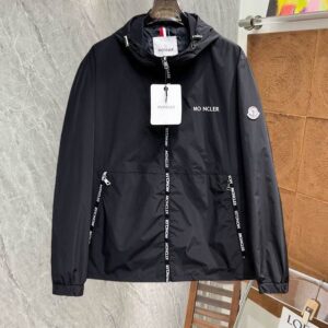 Full image of a black technical hooded windbreaker jacket with white logo taping running vertically down the sides and sleeves, a small chest logo, and a zippered front closure, hanging on a hanger.