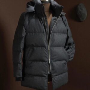 A premium navy or charcoal wool puffer jacket featuring a detachable hood, stand collar, and visible high-quality YKK zipper closure.