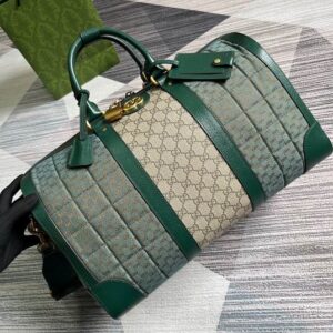 A Gucci Beige GG Supreme Green Quilted Duffle Bag with forest green leather panels, gold-toned hardware, and an interlocking G logo, sized 44 x 28.5 x 24.5 cm.