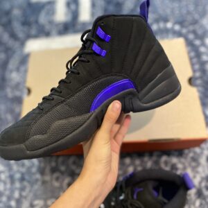 Sideview of a pair of Air Jordan 12 Retro Sneakers held on hand.