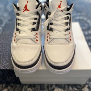 Front view of the sneaker highlighting the Fire Red eyelets and perforated leather collar.