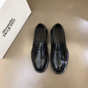 Alexander McQueen Black Leather Penny Loafers with penny slot detail and robust rubber sole.