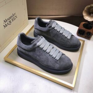 A pair of Alexander McQueen Oversized Grey Suede Sneakers, showcasing the tonal grey suede upper and the signature chunky rubber platform sole.