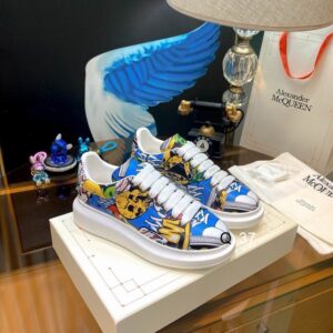 Side view of Alexander McQueen Multicolor Graffiti Oversized Sneakers featuring colorful skull graphics and a thick white platform sole.