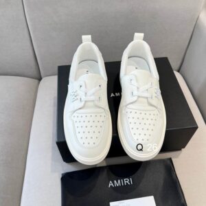 A pair of men's Amiri White Leather Loafers Shoes in all-white leather with a star-perforated toe and thick rubber sole.