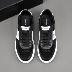 A side and top-down view of Armani Exchange Black White Designer Sneakers featuring black suede, leather, and prominent A|X branding on the side.