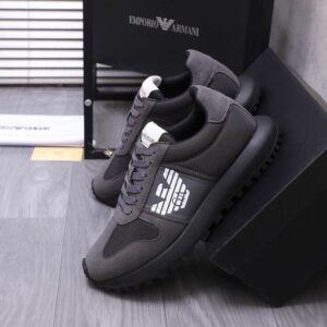 Side view of Armani Grey Sneakers showing the white eagle logo, grey suede overlays, and a thick black treaded sole.