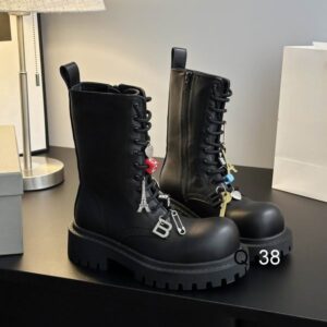 Side view of Balenciaga Black Combat Boots in matte leather with Eiffel Tower and logo charms.
