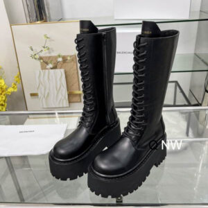 Side view of Balenciaga Black Tall Platform Boots in matte leather with a thick lugged sole and full-length laces.