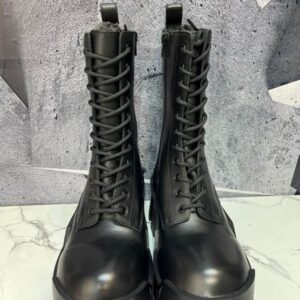 Pair of tall black leather Balenciaga Hummer combat boots with a thick lugged sole and side zipper.