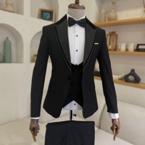 A men's Black Detailed Tuxedo featuring a satin collar, vest, and bow tie on a mannequin.