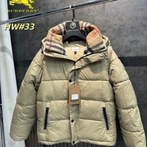 Tan padded jacket (Inspired Burberry) with black hardware, a high snap-button collar, and an iconic check lining visible inside the hood/collar.