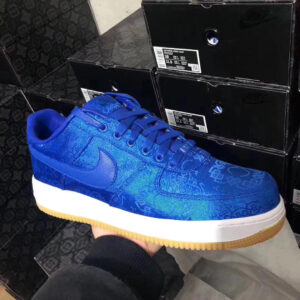 Side and top-down views of the CLOT x Nike Air Force 1 Blue Silk Gum sneaker; features a rich blue silk upper with woven patterning, a white midsole, and a gum rubber outsole; one image shows the shoe being worn, highlighting the texture and color.