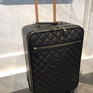 Side view of a Chanel Black Quilted Trolley Suitcase (20-Inch) showing the rose-gold handle and 360-degree wheels