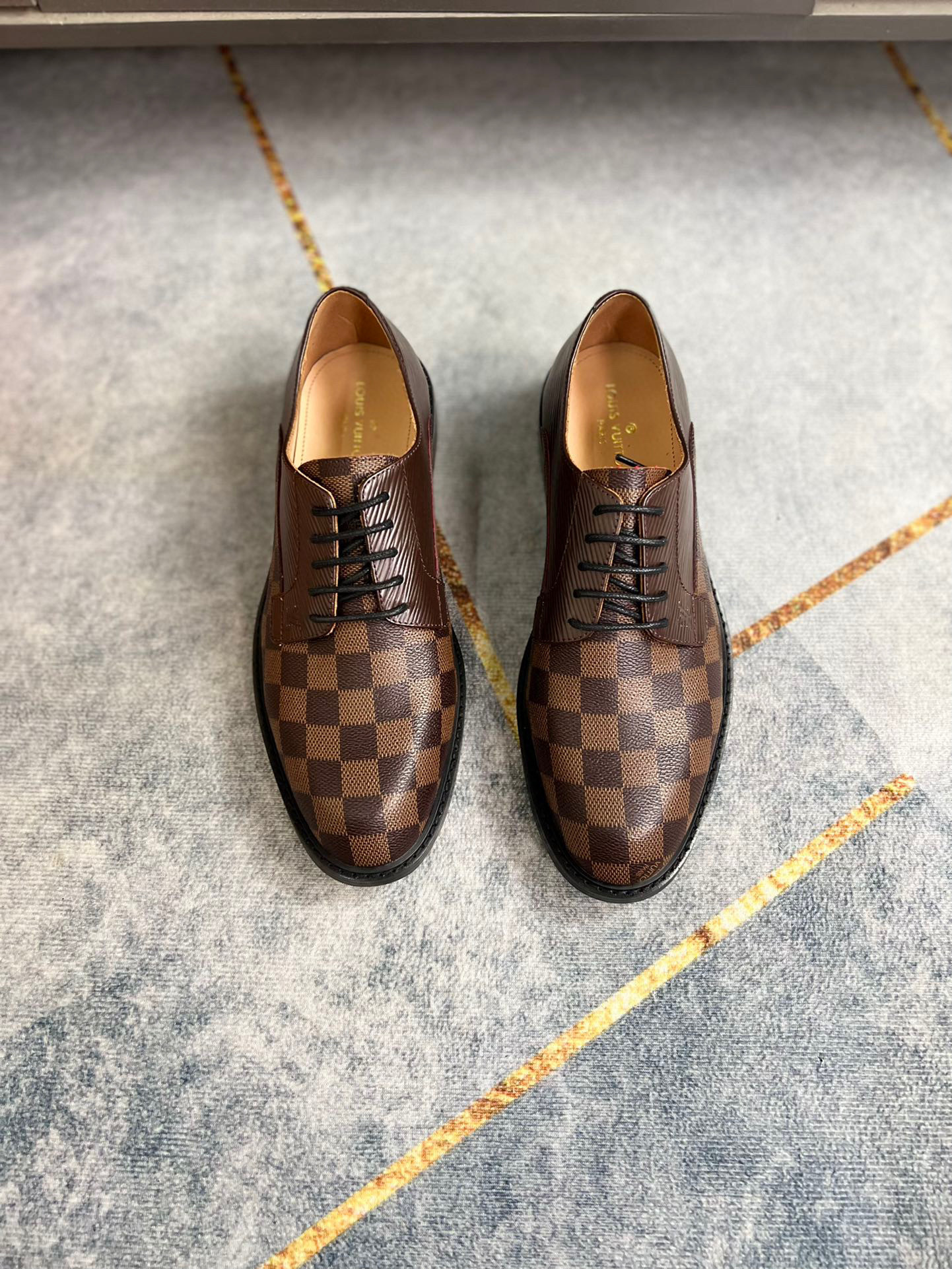Pair of Damier Canvas Classic Derby Shoes in Ebene Brown checkered pattern.