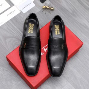: A pair of Ferragamo Black Leather Gancini Loafers, showcasing the polished black calf leather and the signature silver-tone Gancini bit hardware.