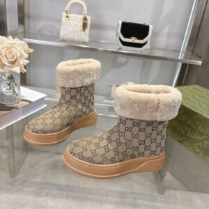 A pair of Gucci Beige Canvas Monogram Elevated Boots with tan platform soles and thick cream shearling collars.
