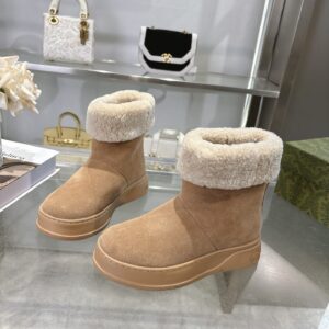 A pair of Gucci Beige Suede Fur-Collar Boots with a thick cream fur trim and matching beige platform soles