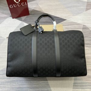 A large Gucci Black GG Monogram Duffle Bag featuring silver hardware and a detachable shoulder strap.