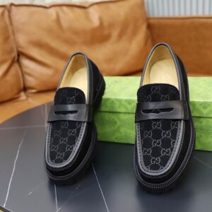 Gucci Black GG Pattern Loafers with embossed GG pattern and green/red detailing on rubber sole.