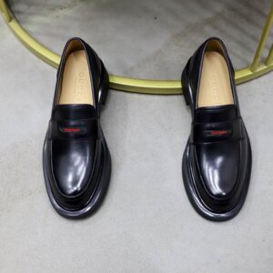 Gucci Black Leather Web Loafers with green and red web stripe detail.