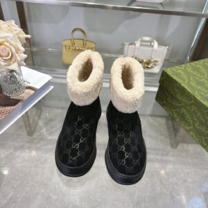 A pair of Gucci Black Monogram Fur-Collar Boots featuring a black GG pattern and thick cream fur trim.