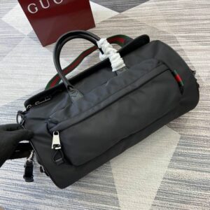 A Gucci Black Nylon Techno Duffle Bag featuring an external front pocket and the signature green and red Web strap, sized 42 x 22 x 22 cm.