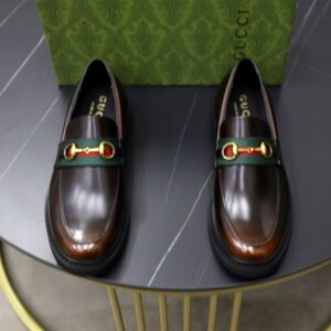 Gucci Brown Leather Horsebit Loafers with antique gold horsebit detail and green/red stripe on midsole.