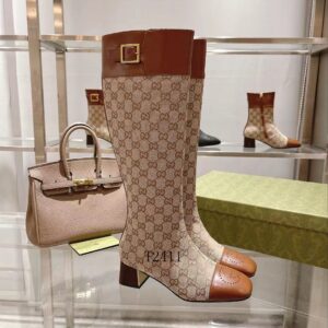 A pair of knee-high boots featuring beige GG monogram canvas, brown leather square toes, and a gold buckle strap at the top.