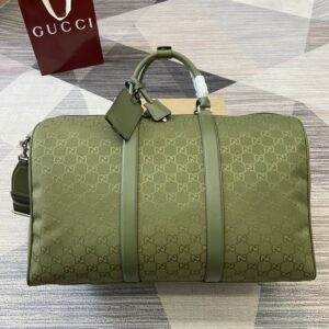 view of a Gucci Green GG Monogram Duffle Bag showing the olive green canvas and leather trim
