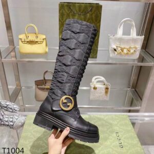 Side view of Gucci Jumbo GG Canvas Lace-Up Boots in Black showing the quilted monogram pattern and thick ribbon laces.