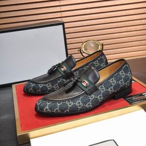 Gucci Navy GG Supreme Horsebit Loafers with tassels and antique gold horsebit detail.