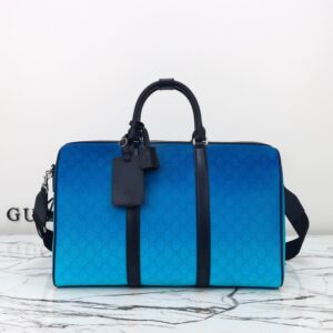 A Gucci Ombre Blue GG Monogram Duffle Bag featuring a blue gradient canvas, black leather trim, and silver hardware, sized 45 x 30 x 24.5 cm.