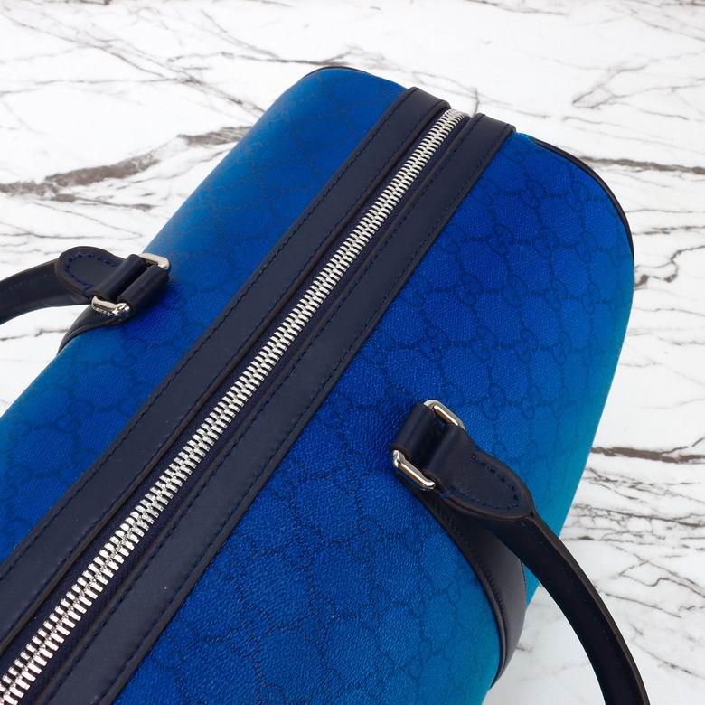A Gucci Ombre Blue GG Monogram Duffle Bag featuring a blue gradient canvas, black leather trim, and silver hardware, sized 45 x 30 x 24.5 cm.