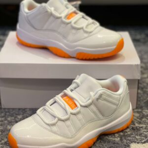 Close-up of the orange translucent outsole and Jumpman logo on the Jordan Retro 11 Blanche Et Orange 11 Retro Low Jordan Orange.