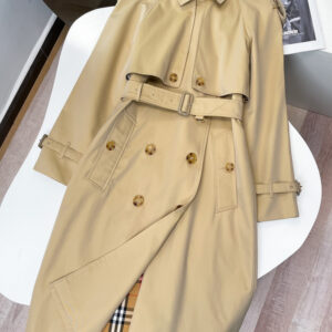 Mid-length double-breasted unisex trench coat in Light Beige/Honey with belted waist and classic check lining. Tailored Kensington-style.