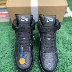 Front view of LV X NIKE AIR FORCE 1 HIGH TOP BLACK sneakers with monogram leather and co-branded tongue labels on a green carpet.