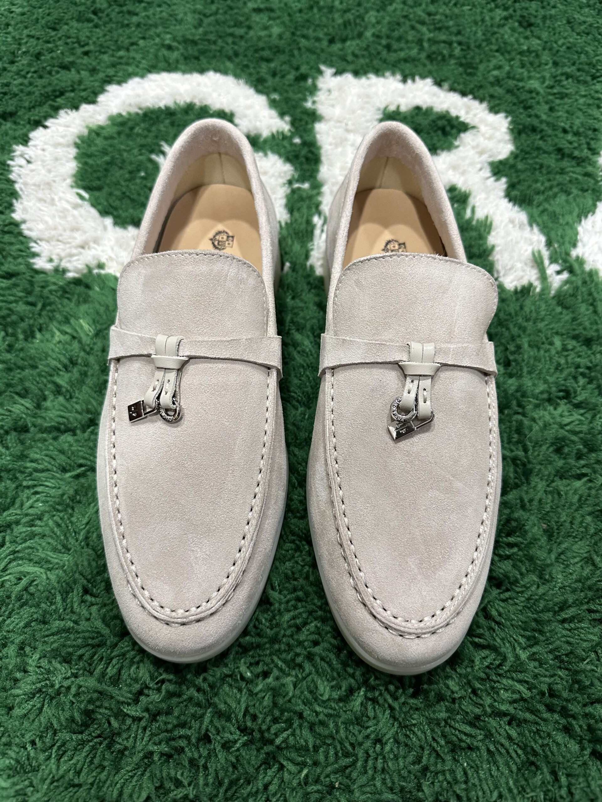 Luxury beige suede Loro Piana Summer Walk loafers with white rubber soles on a neutral background.