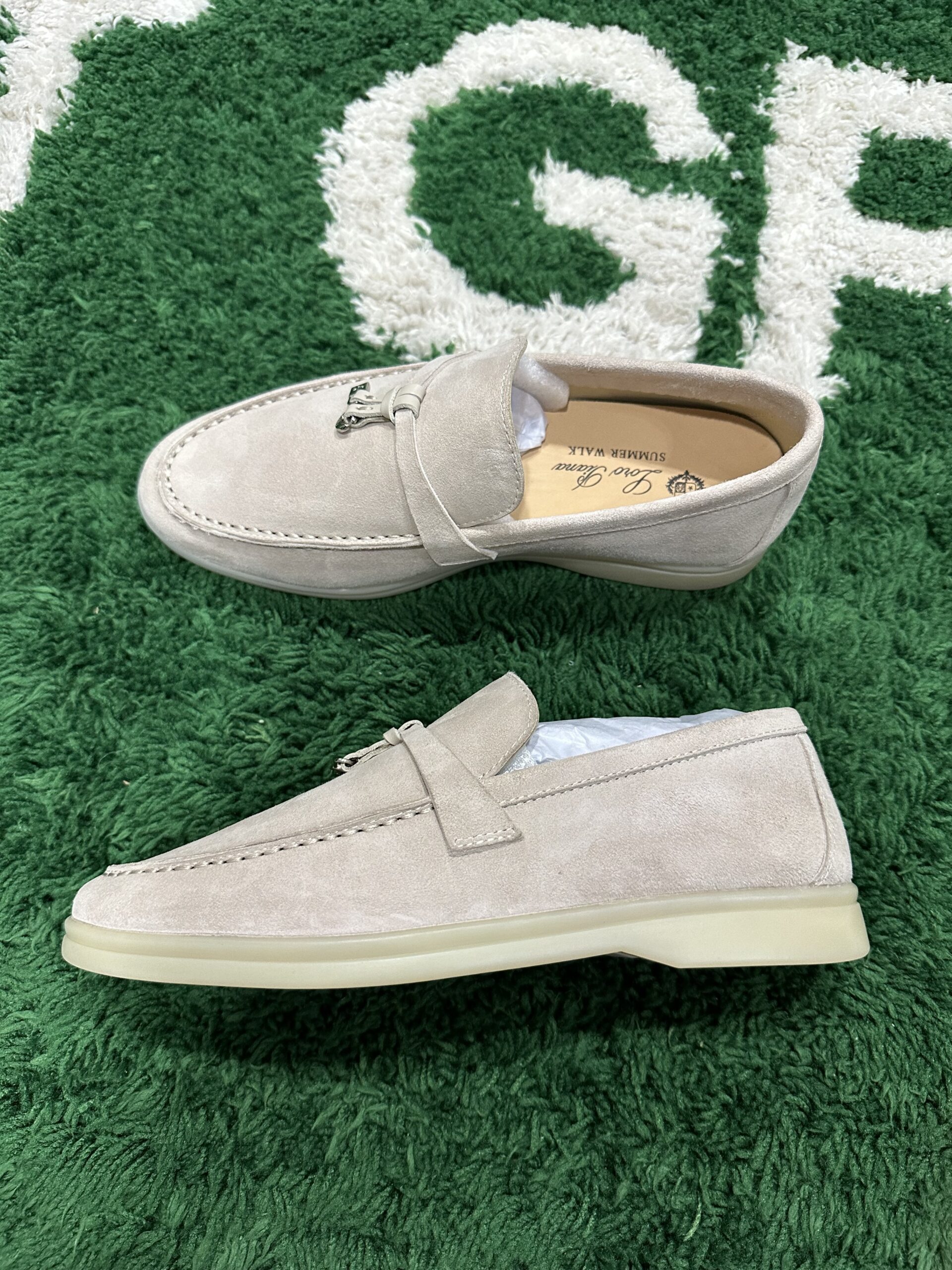 Luxury beige suede Loro Piana Summer Walk loafers with white rubber soles on a neutral background.