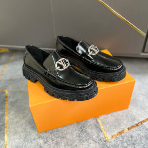 Louis Vuitton Black Academy Loafers with chunky platform soles and silver LV Link hardware on an orange box.