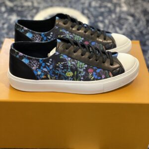 A professional shot of the Louis Vuitton Black Floral Sneaker featuring a multicolored floral print on a black base with a white rubber toe cap.